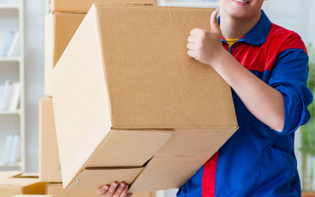 Team organizing and packing items into labeled moving boxes